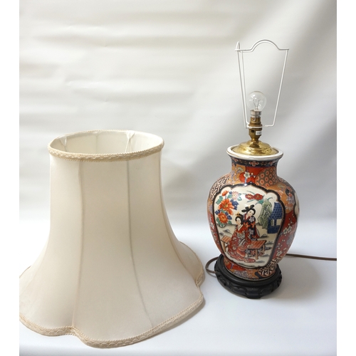 298 - JAPANESE IMARI PATTERN TABLE LAMP
on a pierced hardwood stand, the shaped body with decorative panel... 