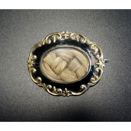 86 - VICTORIAN ENAMEL DECORATED GOLD MOURNING BROOCH
the central glazed panel revealing entwined hair, su... 