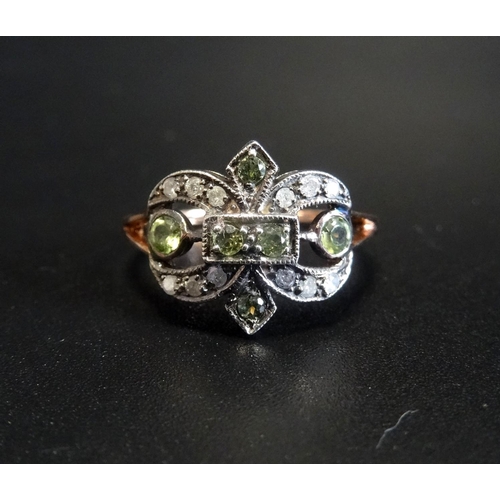 99 - DIAMOND AND PERIDOT CLUSTER DRESS RING
on fifteen carat rose gold shank with split shoulders and sil... 