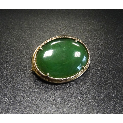 139 - JADE COLOURED HARDSTONE BROOCH
in silver gilt mount, 2.7cm wide - RETURNED