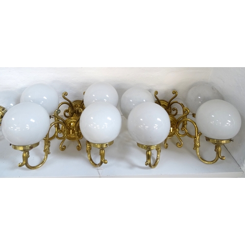 525 - SET OF FOUR GILT BRASS WALL LIGHTS
each with a pair of scroll arms and opaque circular glass shades ... 