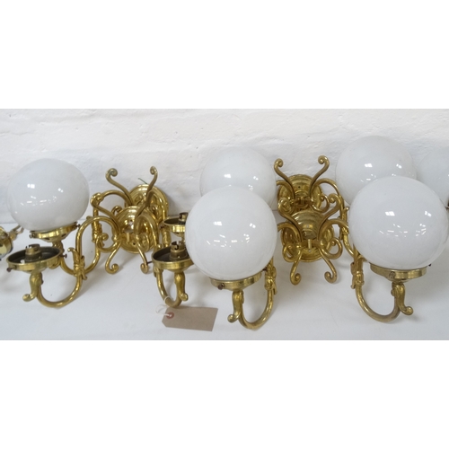 527 - SET OF FOUR GILT BRASS WALL LIGHTS
each with a pair of scroll arms and five opaque circular glass sh... 