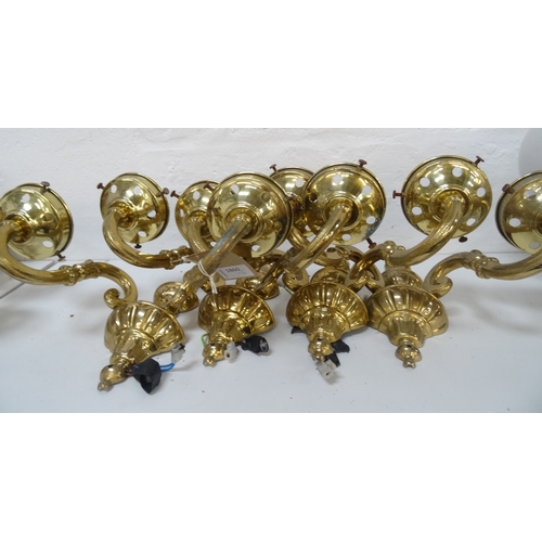 528 - SET OF FOUR GILT BRASS AND STEEL WALL LIGHTS
each with a tapering and shaped back plate with a pair ... 