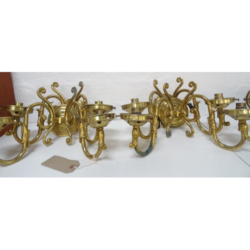 529 - SET OF FOUR GILT BRASS WALL LIGHTS
each with a pair of scroll arms and opaque circular glass shades ... 