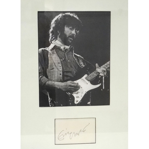 348 - ERIC CLAPTON SIGNATURE PIECE
a photographic image mounted above a signature card, framed and under g... 