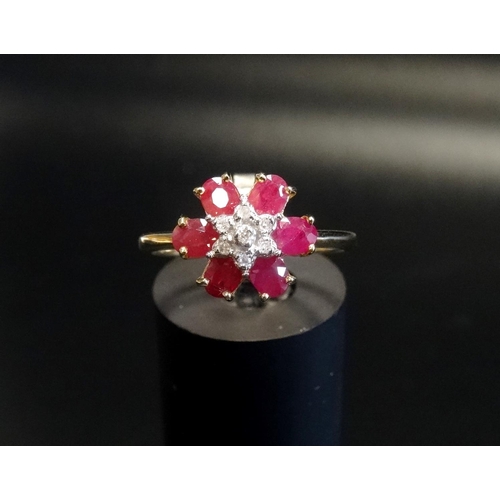 119 - RUBY AND DIAMOND FLORAL CLUSTER RING
the central cluster of small diamonds within surround of six ru... 