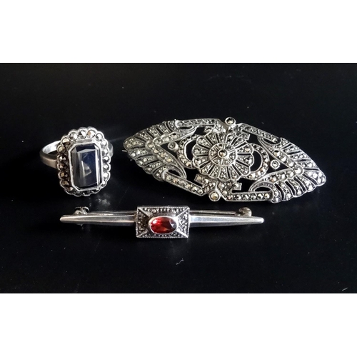 133 - THREE PIECES OF MARCASITE JEWELLERY
comprising a silver ring, a garnet and marcasite set silver broo... 