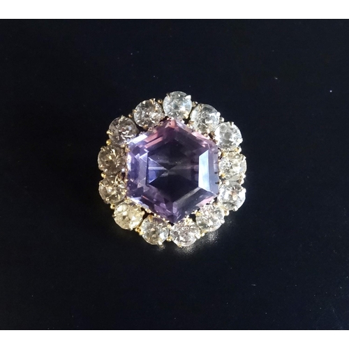 166 - AMETHYST AND FACETED GLASS BROOCH
the central hexagonal amethyst in clear glass surround, in nine ca... 