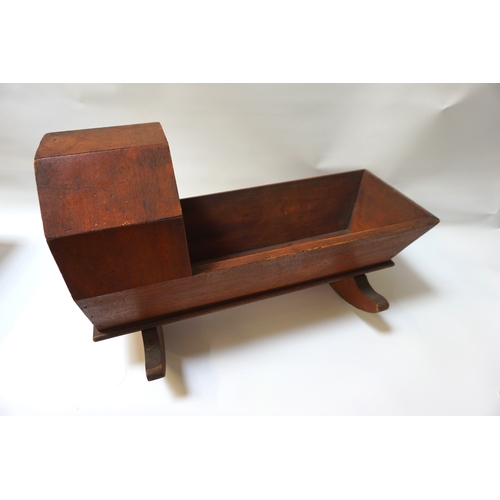 288 - MAHOGANY DOLL'S ROCKING CRIB
early 20th century, with hood, sides and raised on rocking base, 48cm l... 