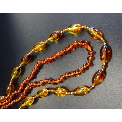 122 - TWO MODERN AMBER BEAD NECKLACES
one with small individually knotted orange coloured beads; the other... 