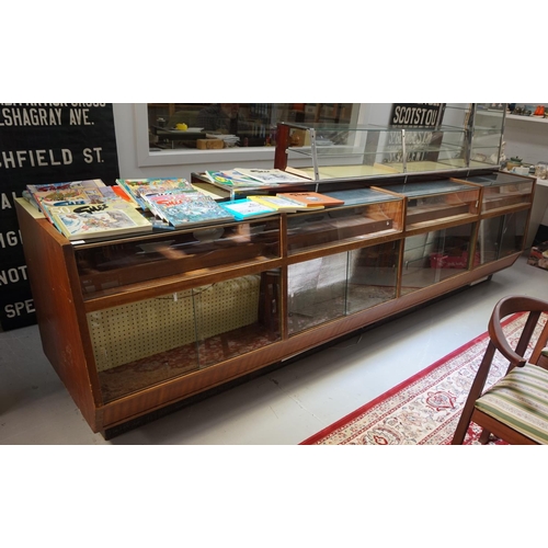 515 - LARGE 1950s TEAK AND GLAZED DISPLAY CABINET
in four combined sections, with upper shelving areas abo... 