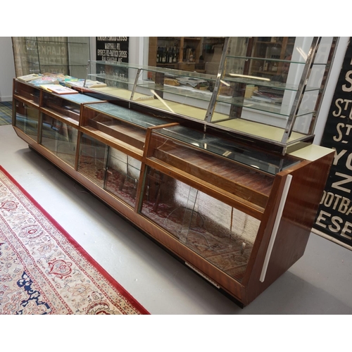 515 - LARGE 1950s TEAK AND GLAZED DISPLAY CABINET
in four combined sections, with upper shelving areas abo... 