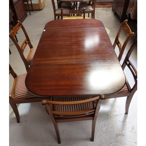 522 - GEORGIAN STYLE MAHOGANY AND CROSSBANDED DINING TABLE
with shaped drop flaps, standing on a turned co... 