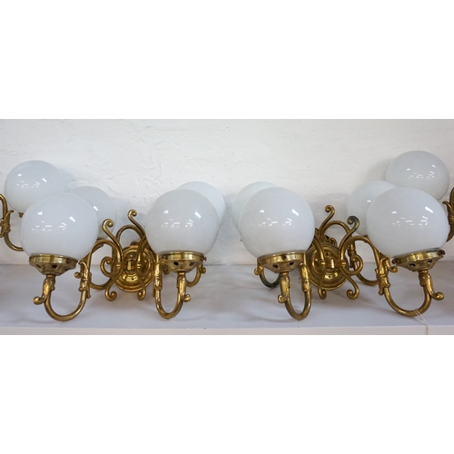 529 - SET OF FOUR GILT BRASS WALL LIGHTS
each with a pair of scroll arms and opaque circular glass shades ... 