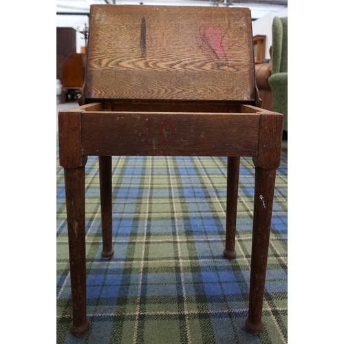 174 - CHILD'S OAK DESK 
early 20th century, with metal hinge work, raised on tapering legs with shaped fee... 