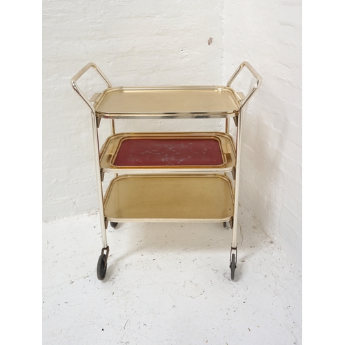 413 - WOODMET GILT METAL HOSTESS TROLLEY
with a removable top tier tray above two lower tiers, on wheels, ... 