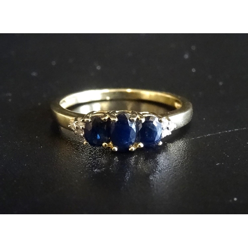 59 - SAPPHIRE AND DIAMOND RING
the three graduated oval cut sapphires flanked by small diamonds to the sh... 