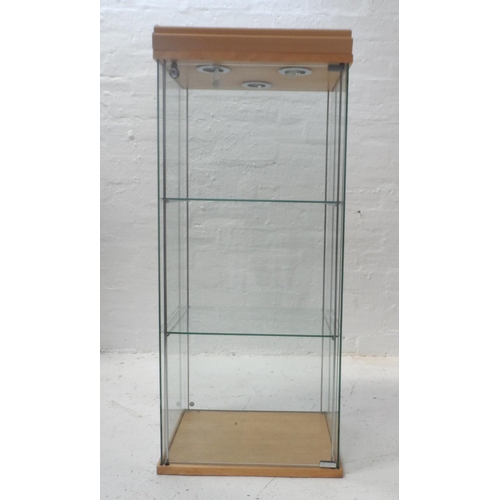 477 - ILLUMINATED GLASS DISPLAY CABINET
with a locking door, two glass shelves and wall fixings, 109cm x 4... 