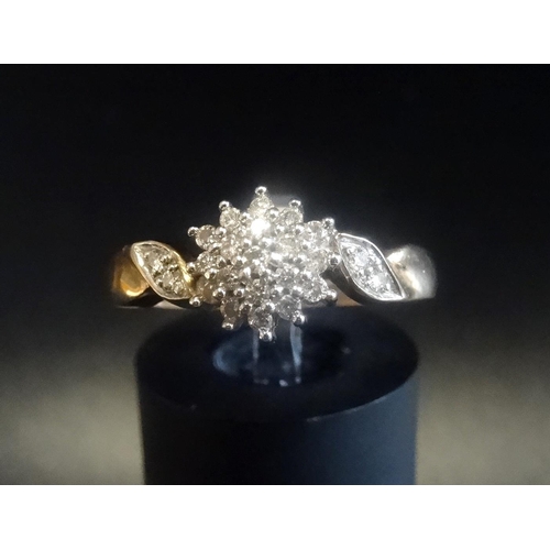 23 - DIAMOND CLUSTER RING
with stepped setting and on nine carat gold shank with further small diamonds t... 