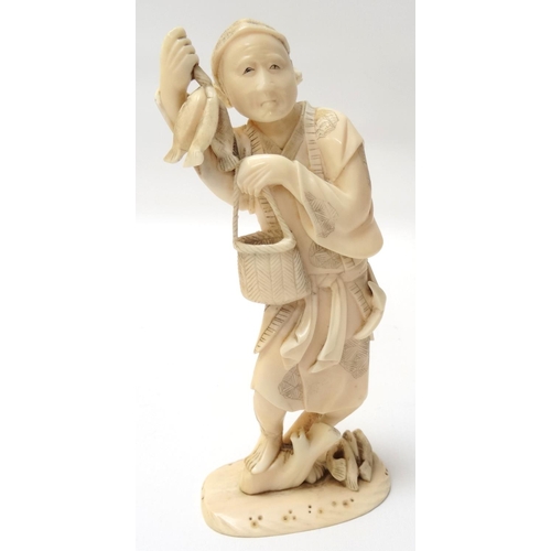 282 - CHINESE CARVED IVORY FISHERMAN
standing on a tree stump with fish beside him, and holding three fish... 