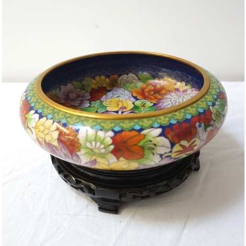 252 - CHINESE CLOISONNE CENTRE BOWL
decorated with colourfull flowers on a circular hardwood stand, 23cm d... 