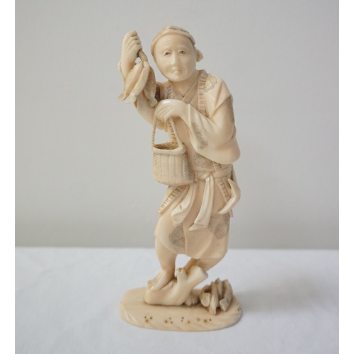 282 - CHINESE CARVED IVORY FISHERMAN
standing on a tree stump with fish beside him, and holding three fish... 