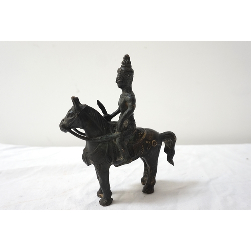 291 - TIBETAN BRONZE OF A WARRIOR ON HORSEBACK
clutching his raised sword, 16cm high