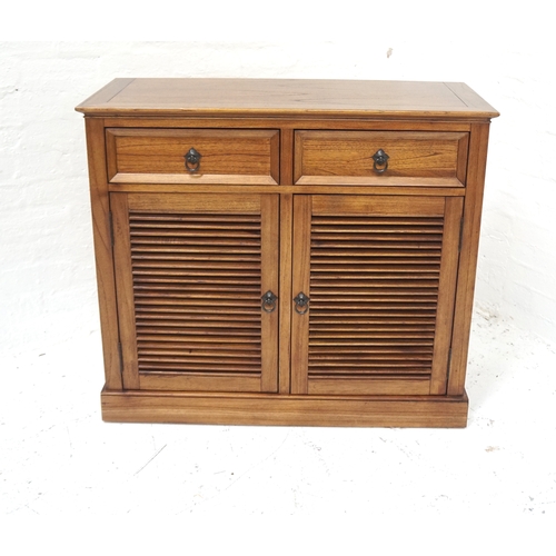 485 - TEAK SIDE CABINET
with a crossbanded moulded top above two frieze drawers with a pair of slatted cup... 