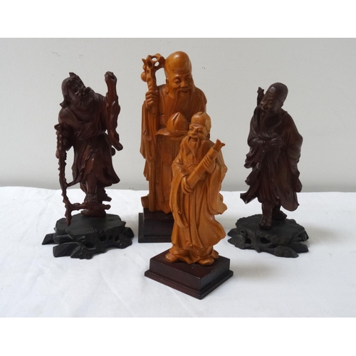 299 - FOUR CHINESE CARVED WOODEN FIGURES
depicting a wiseman, scholar, farmer and a traveller, all on shap... 