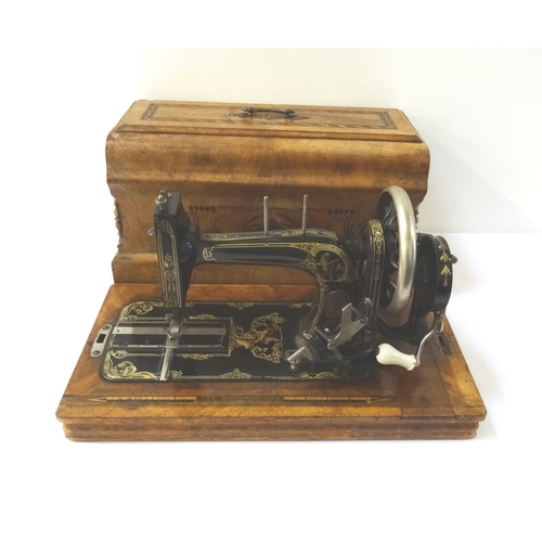 307 - VINTAGE GERMAN METAL SEWING MACHINE
contained in a walnut and inlaid case