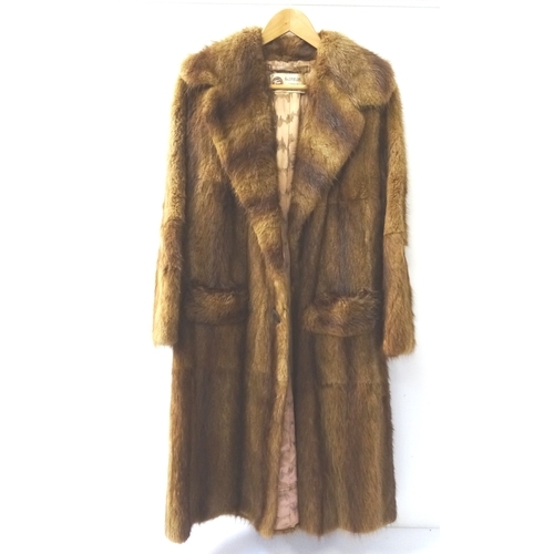 405 - LADYS VINTAGE MUSQUASH FULL LENGTH COAT
with pockets and button fastening, bearing a trade label for... 