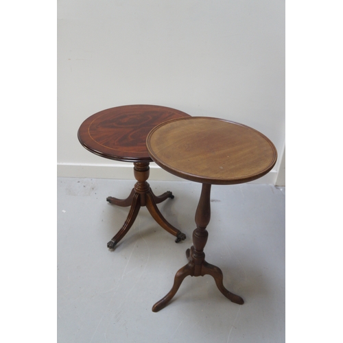 580 - MAHOGANY WINE TABLE
with a circular quarter veneered top on a turned column with four outswept reede... 