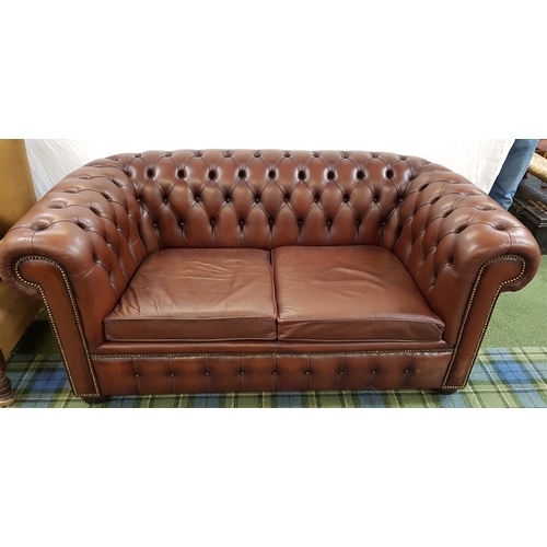 578 - CHESTERFIELD TWO SEAT SOFA
in brown leather with a button back and arms with decorative stud detail,... 