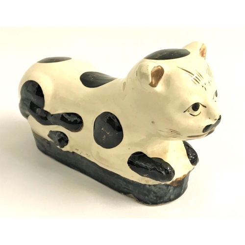 255 - CHINESE CI ZHOU WARE POTTERY CAT
lying recumbent with a cream coloured body with brown markings, wit... 