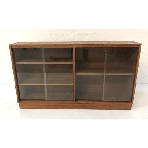 488 - TEAK CABINET
with a rectangular top above two pairs of glass sliding doors with a shelved interior, ... 