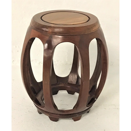 491 - CHINESE ZITAN BARREL SHAPED STAND
with a circular top above shaped supports 45cm high