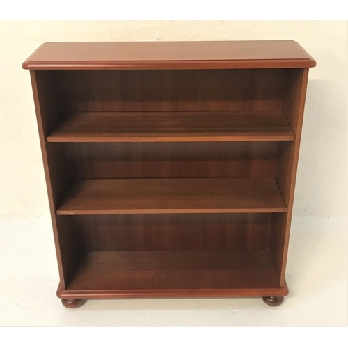 497 - MAHOGANY OPEN BOOKCASE 
with a moulded top above two adjustable shelves, standing on flattened bun f... 