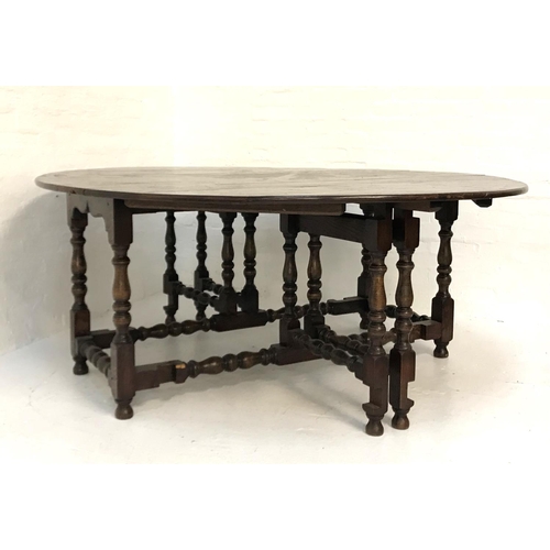 518 - VERY LARGE OAK GATELEG TABLE
with shaped drop flaps, standing on turned supports united by stretcher... 