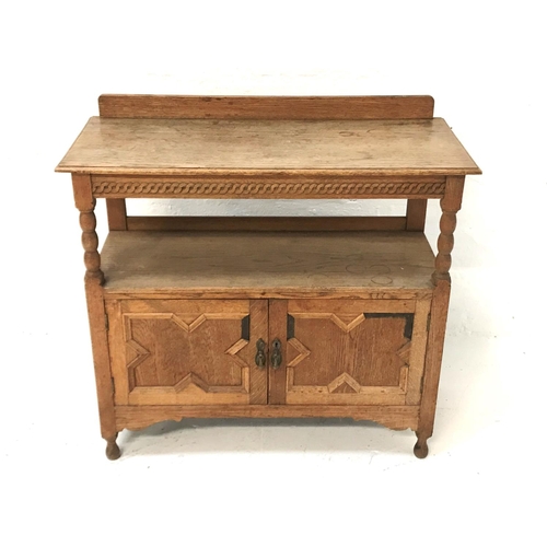 525 - OAK BUFFET
with a moulded top and raised back supported by columns above a lower shelf with two pane... 