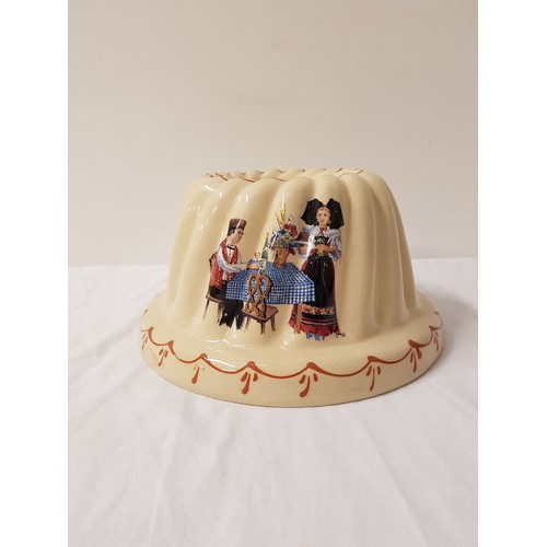 270 - UNUSUAL NORWEGIAN DESIGNED BUNDT CAKE MOULD
of circular ribbed shape, decorated with figures by a ta... 