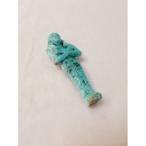 306 - EGYPTIAN PORCELAIN FIGURE
of a pharaoh with his arms crossed over his chest, in a turquoise glaze, h... 