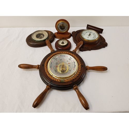 330 - SELECTION OF ANEROID BAROMETERS
one circular shaped contained in a ships wheel, one of shaped outlin... 