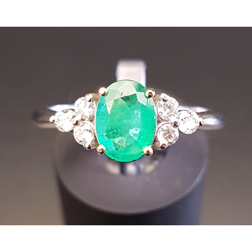 102 - EMERALD AND DIAMOND RING
the central oval cut emerald approximately 0.74cts flanked by three diamond... 