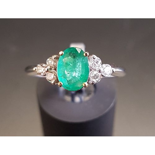 102 - EMERALD AND DIAMOND RING
the central oval cut emerald approximately 0.74cts flanked by three diamond... 