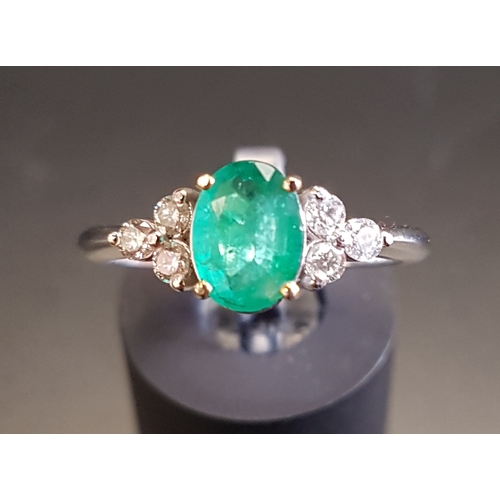 102 - EMERALD AND DIAMOND RING
the central oval cut emerald approximately 0.74cts flanked by three diamond... 