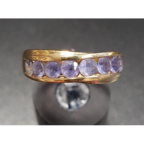 95 - CHANNEL SET IOLITE DRESS RING
in fourteen carat gold, ring size P