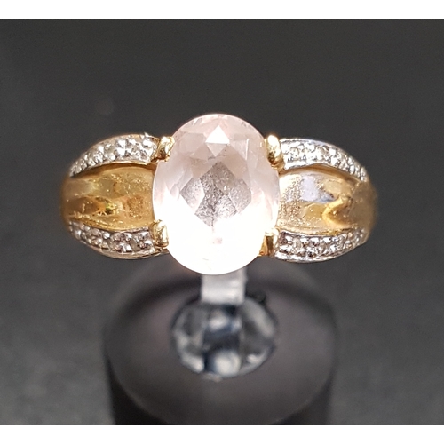 101 - KUNZITE AND DIAMOND DRESS RING
the central oval cut kunzite flanked by diamond set shoulders, on fou... 