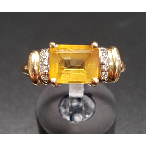 112 - CITRINE AND DIAMOND DRESS RING
the central emerald cut citrine flanked by diamond set shoulders, on ... 