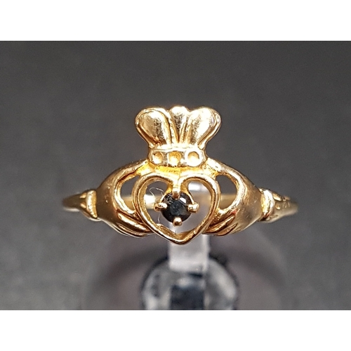 140 - SAPPHIRE SET NINE CARAT GOLD CLADDAGH RING
the small round cut sapphire to the centre of the heart, ... 