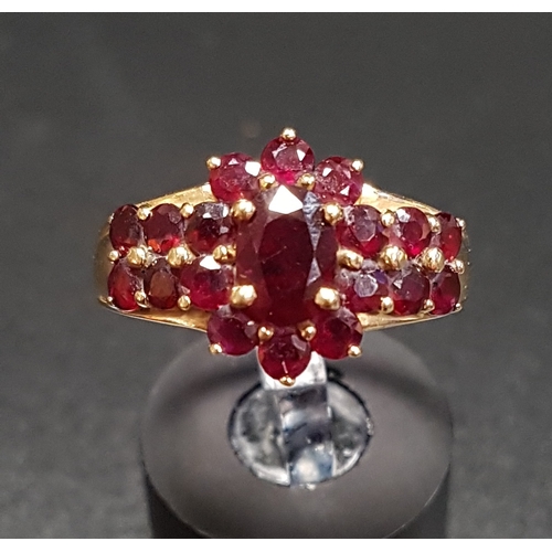 150 - GARNET CLUSTER RING
the central cluster flanked by further garnets to the shoulders, on fourteen car... 